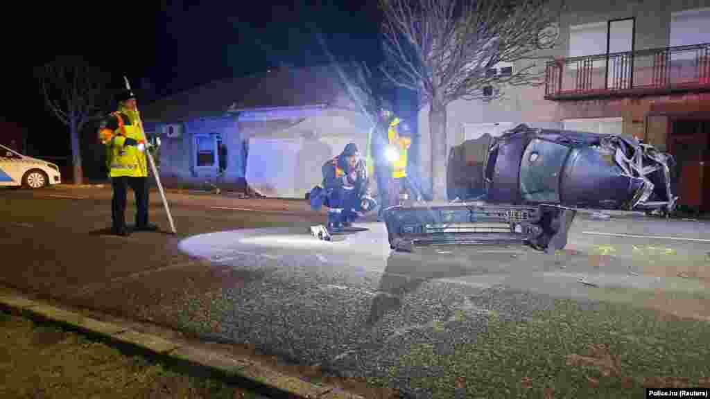 Police examine the scene of an accident near the Serbian border where a car carrying migrants crashed into a house in Morahalom, Hungary, on December 14. Seven migrants were killed. Police said the driver of the car refused to stop for a police check and tried to escape at high speed.