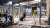 Asylum seekers stand near the pedestrian crossing port on the U.S.-Mexico border in Tijuana, Mexico.