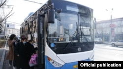 Armenia - People board a public bus in Yerevan, December 12, 2021.