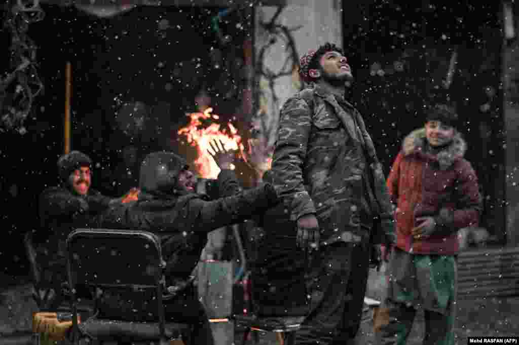 Afghan youths enjoy the first snow of the year in Kabul on December 15.