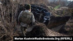 A Ukrainian soldier enters a trench along the frontline in the Luhansk Region, Ukraine, December 7, 2021.