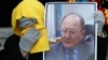 A woman holds a portrait of Altynbek Sarsenbaiuly at the funeral of the prominent opposition politician in Almaty in 2006.