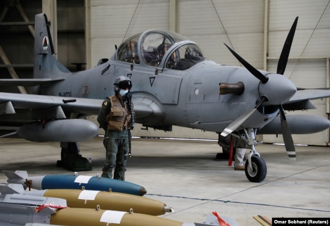 An Afghan pilot stands next to A-29 Super Tucano during a handover ceremony from U.S. to Afghan forces in Kabul on September 17, 2020.