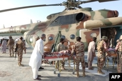 Injured survivors are transported in a Pakistani Army helicopter following the earthquake in the remote mountainous district of Harnai.