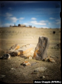 A simple cross-stone near a chapel overlooking Lake Sevan.