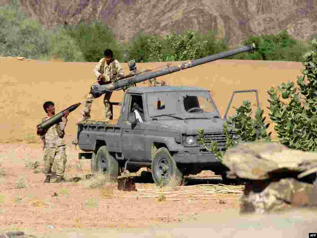 Fighters loyal to Yemen&#39;s Saudi-backed government load a recoilless rifle in the country&#39;s northeastern province of Marib on October 27. While Saudi Arabia backs Yemen&#39;s internationally recognized, but embattled government, Iran is widely believed to support the Huthi rebels as part of a quest to increase its influence in the region.&nbsp;