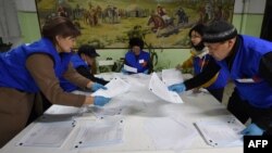 Election workers count ballots at a polling station in the village of Gornaya Mayevka outside Bishkek following Kyrgyzstan's parliamentary elections on November 28.