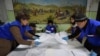 Members of a local election commission count votes as part of Kyrgyzstan's parliamentary elections in the village of Gornaya Mayevka, outside Bishkek, on November 28. 