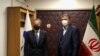 IAEA chief Rafael Grossi (left) meets with Atomic Energy Organization head Mohammad Eslami in Tehran on November 23.