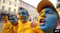 Ukrainian fans cheer at a fan zone ahead of the Euro 2012 match with Sweden in central Lviv.