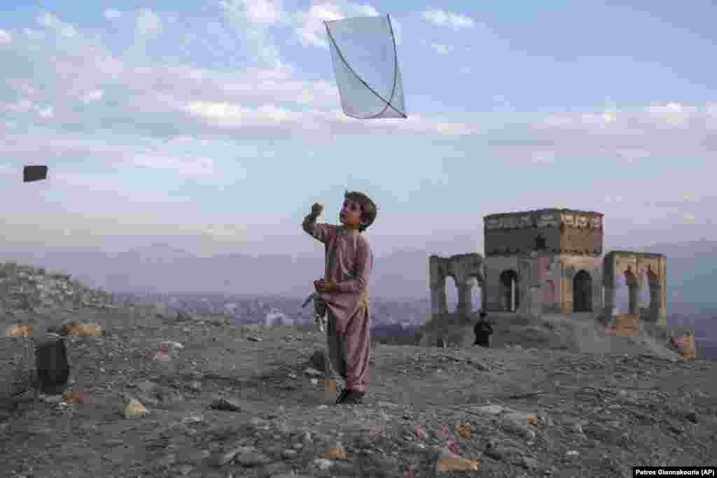 A boy flies a kite on Tape Nadir Khan hill in Kabul.