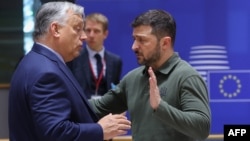 Hungarian Prime Minister Viktor Orban (left) talks with Ukrainian President Volodymyr Zelenskiy during the European Council Summit in Brussels on June 27.