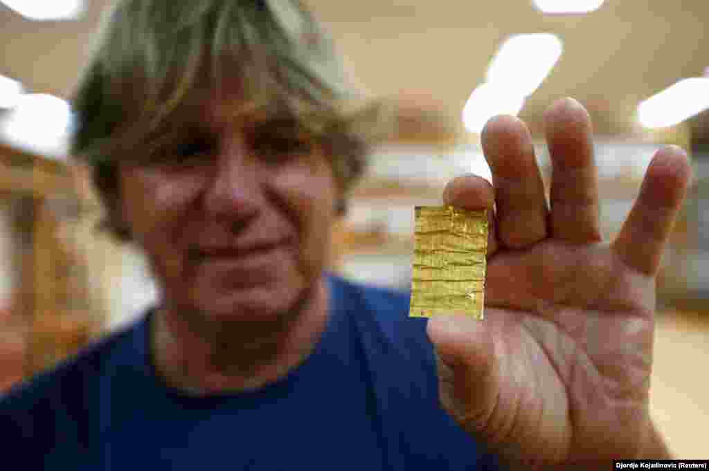 In this photo from 2016, Korac displays a golden amulet that was discovered at the ancient city. Excavations at Viminacium have been going on since 1882. However, archaeologists estimate they have only scoured 5 percent of the site, which they say is 450 hectares (bigger than New York&#39;s Central Park) and unusual in not being buried under a modern city.