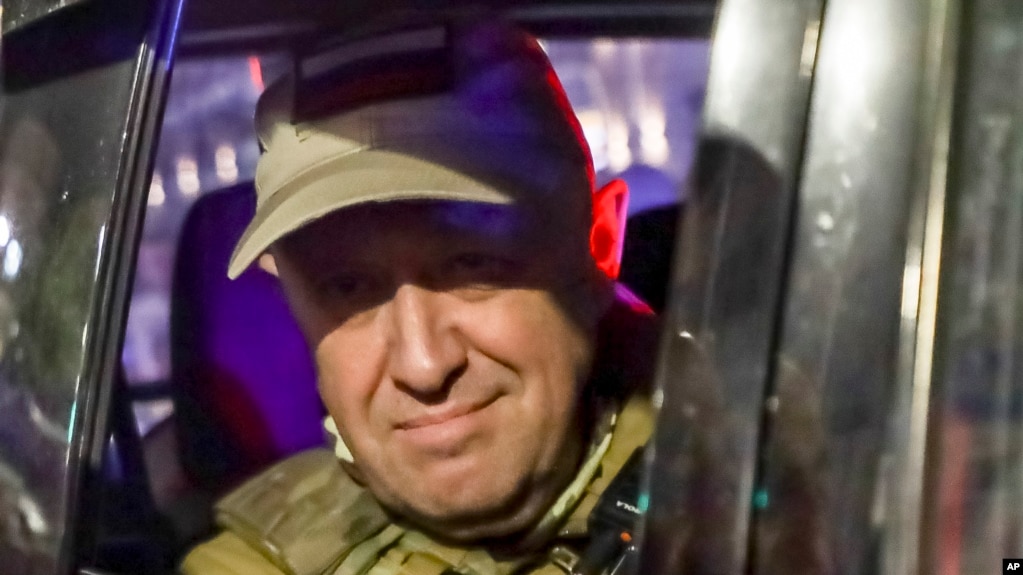 Wagner chief Yevgeny Prigozhin smiles for cameras as he departs Rostov-on-Don, Russia, on June 24 after calling his mercenary troops to stand down on a "march of justice" to Moscow.