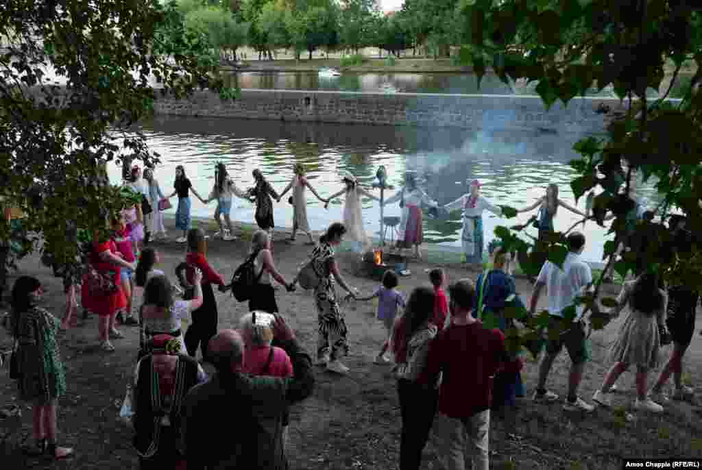 Ukrainians dance around a fire after the effigy was burned. Historians disagree over the exact history of Ivan Kupala night, but some believe it originally involved human sacrifice. Effigies now stand in place of human victims.&nbsp;