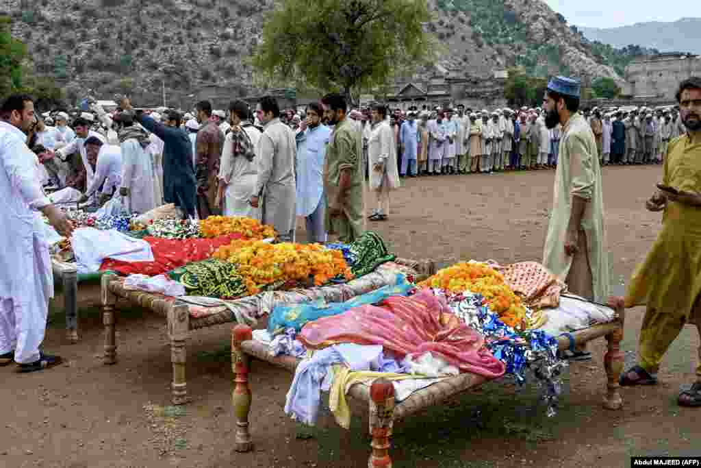  People gather to offer prayers during a funeral for victims who died in flash flooding in Darra Adamkhel, Khyber Pakhtunkhwa Province, Pakistan. &nbsp; 