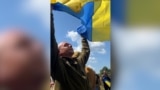 Flags, Tears, And Kneeling As Ukrainian Soldiers Return From Russian Captivity