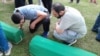 The remains of 14 recently identified victims of the 1995 Srebrenica massacre being prepared for burial