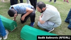 The remains of 14 recently identified victims of the 1995 Srebrenica massacre being prepared for burial