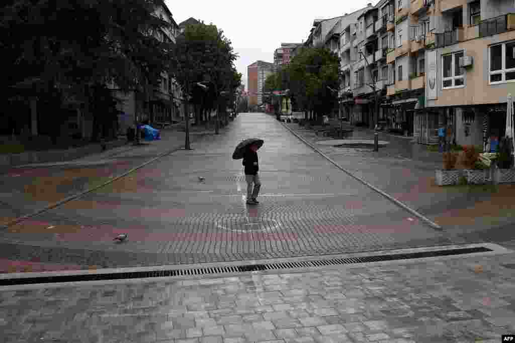 A man walks along the main pedestrian street in the northern Kosovar municipality of Mitrovica. Four towns in the Serb-majority region held extraordinary local elections on April 21 to decide whether to oust their ethnic Albanian mayors.&nbsp;The Central Election Commission said turnout fell far short of the 50 percent required to validate the results and therefore the election failed.