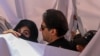 Former Pakistan Prime Minister Imran Khan (center) with his wife, Bushra Bibi (left), arrive to appear at a high court in Lahore in May 2023. 
