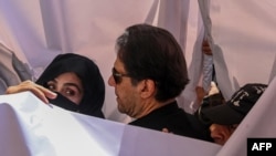 Former Pakistan Prime Minister Imran Khan and his wife, Bushra (left), arrive at a court in Lahore in May 2023.