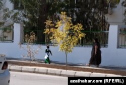 A girl walk home from school in Ashgabat.