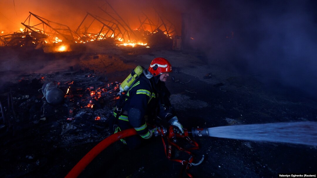 A firefighter works at the site of a warehouse heavily damaged during a Russian missile strike in Kyiv on December 29.