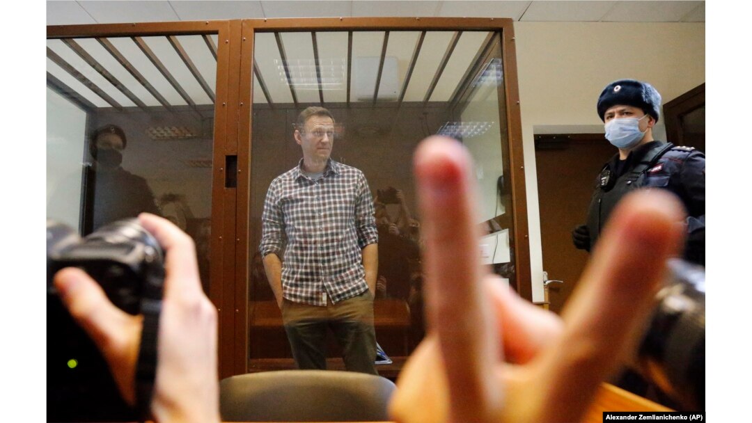 Navalny stands in a cage in a Moscow courtroom on February 20, 2021. His decision to confront Putin’s government directly at the cost of his own freedom became for many a defining and inspirational example.