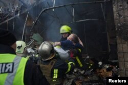 Рятувальники ДСНС рятують пораненого цивільного внаслідок російського обстрілу Києва. 2 січня 2024 року