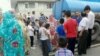 People wait to draw water from a truck in Tabriz on August 4.