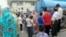 People wait to draw water from a truck in Tabriz on August 4.
