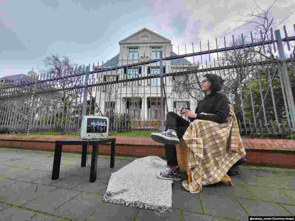 This Russian activist watches Swan Lake outside the Russian Embassy in The Hague. The protester is referencing the Soviet convention of broadcasting the ballet on state TV in the wake of the death of a leader in the Kremlin. &nbsp;