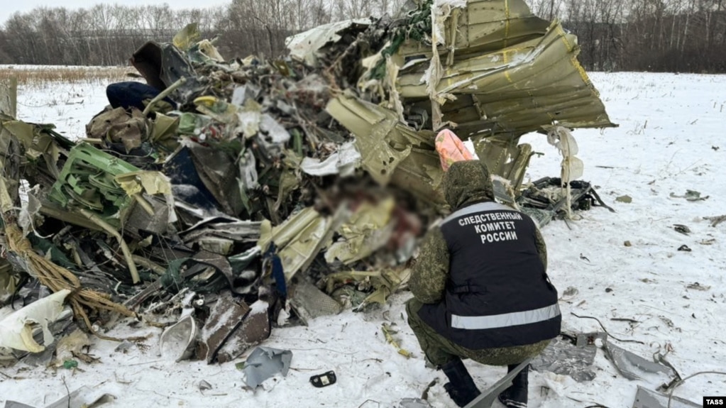 An investigator examines debris at the crash site of an Ilyushin Il-76 aircraft, which came down near the western Russian city of Belgorod on January 24. 