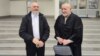 Muharem Stulanovic (left) and his lawyer Duško Tomic speak to reporters outside the court in Banja Luka on February 29.