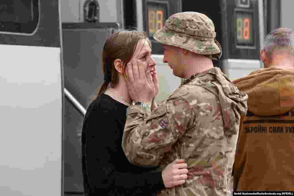 A Ukrainian soldier says goodbye to a loved one at the train station in&nbsp;Kramatorsk.