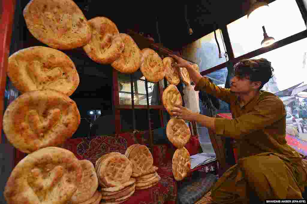 A man puts up traditional Afghani naan for sale in Karachi, Pakistan. The sales of Afghani naan have significantly dropped in the neighborhoods after the Pakistani government&#39;s deadline to expel undocumented Afghan immigrants expired on November 1 and thousands of refugees returned to their homeland.