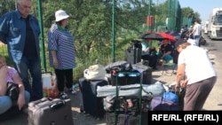 Scores of Ukrainians hoping to visit their homes in Russian-occupied areas are being stranded in no-man's-land as they await clearance to enter.