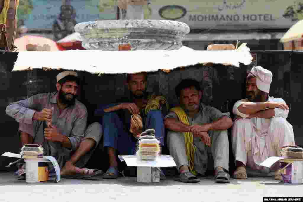 Laborers who work on daily wages wait to get hired in Peshawar, Pakistan.