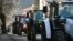 Земеделци карат тракторите си по време на протестна блокада на пътя между Брезник и границата със Сърбия, 6 февруари 2024 г.