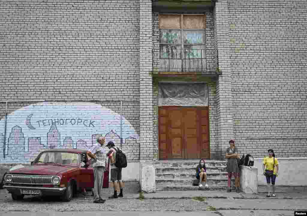 Local residents wait for evacuation from the village of Stepnohirsk near the front line in southeastern Ukraine.&nbsp;