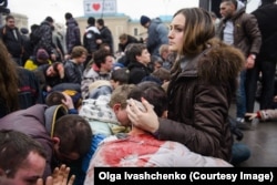 Wounded supporters of Ukraine's new government are made to kneel on Kharkiv’s central square by pro-Russian crowds on March 1, 2014. Euromaidan protests had ousted Ukraine's Kremlin-aligned president, Viktor Yanukovych, from power in Kyiv several days earlier.
