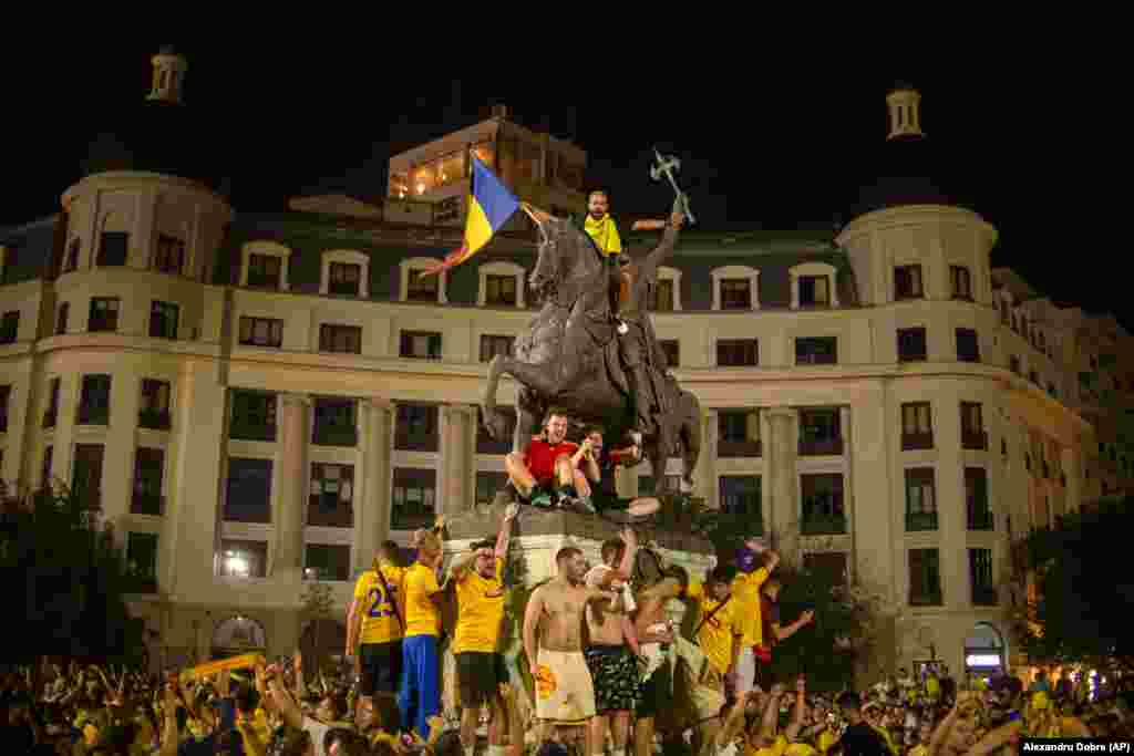 Romanian soccer fans celebrate in downtown Bucharest after their country&#39;s national soccer team advanced to the knockout stages of the Euro 2024 tournament.