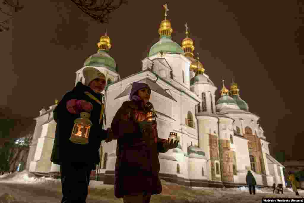 Two girls photographed on the evening of December 10 hold lanterns containing a flame that was carried from Bethlehem to Kyiv&#39;s Saint Sophia Cathedral.&nbsp;