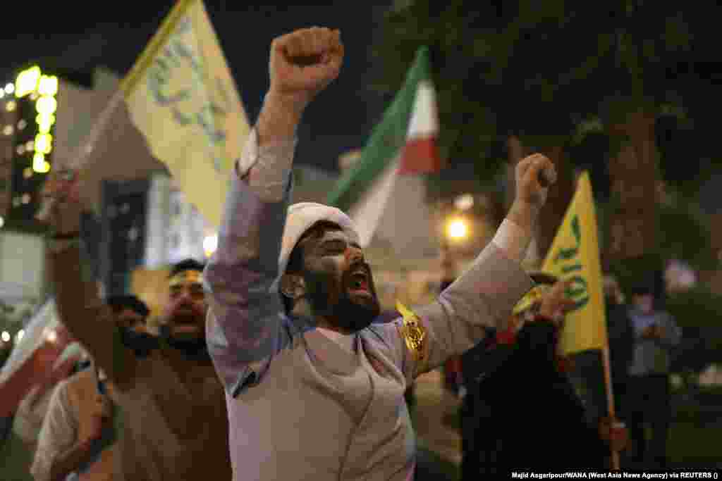 Iranians celebrate in Tehran after the Islamic Revolutionary Guards Corps (IRGC) launched air strikes on Israel on April 14. Iran launched an unprecedented, large-scale missile attack on Israel, triggering air-raid sirens across the country as its air defenses appeared to destroy many of the incoming projectiles.