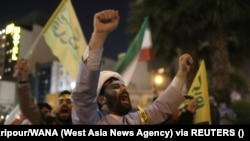 Iranians celebrate in Tehran after the Islamic Revolutionary Guards Corps (IRGC) launched air strikes on Israel on April 14.<br />
<br />
Iran launched an unprecedented, large-scale missile attack on Israel, triggering air-raid sirens across the country as its air defenses appeared to destroy many of the incoming projectiles.