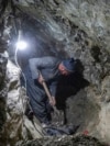 An Afghan miner digs inside a tunnel of a gold mine in the mountains of the Yaftal Sufla district in Badakhshan province. 