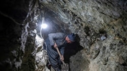 An Afghan miner digs inside a tunnel of a gold mine in the mountains of the Yaftal Sufla district in Badakhshan province. 