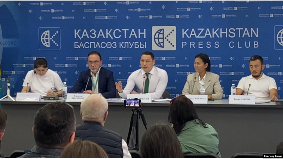 Sanzhar Boqaev (center) and other activists against the car-recycling system hold a press conference in Almaty on July 15.