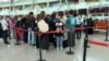 People line up at check-in desks at the airport in Zvartnots, west of Yerevan, in April.
